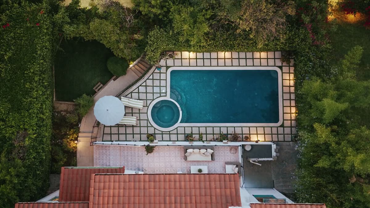 Camera rising above the terracotta roof for an overhead view of the property